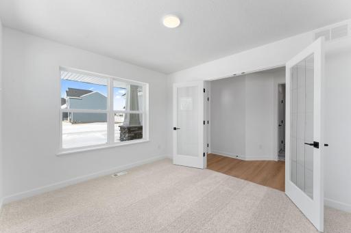 (Photo of a similar home, actual finishes may vary) Situated on the main level at the front of the home, the flex space has a variety of possible uses such as a home office, as itâs configured here.
