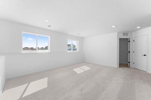 (Photo of a similar home, actual finishes may vary) The finished lower level comes with a sprawling game room to provide additional entertainment space, as well as fourth bedroom and a third bathroom.