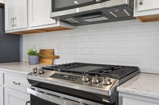 Timeless finishes and stainless steel appliances elevate the space.
