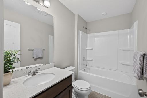 Full bath with timeless details and beautiful tile, cabinetry, and fixtures.