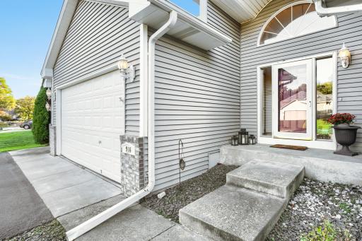 A dramatic covered entryway with soaring architectural details and an elegant arched window creates a grand first impression, while the charming bay window adds character and natural light.