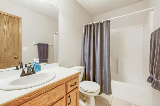 Convenient upper-level full bath serves the two additional bedrooms and features a tub/shower combination, spacious vanity, and easy-care tile flooring.