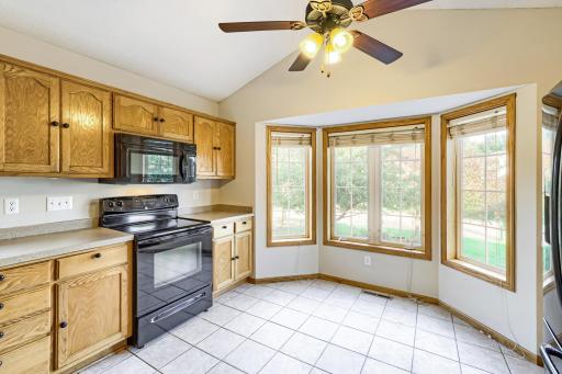 Beautiful sun-filled kitchen features a charming bay window with plenty of space for a cozy bistro table for two. The perfect spot to enjoy your morning coffee while taking in the outdoor views!