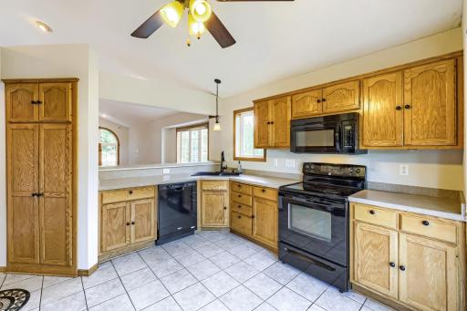 This spacious kitchen offers an abundance of oak cabinetry, generous counter space, and a convenient full-height pantry closet for extra storage. The open design and breakfast bar make everyday living and entertaining a breeze!