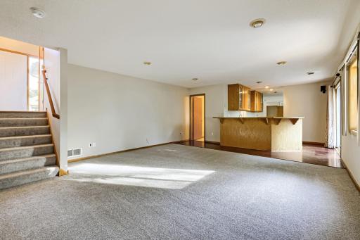 Spacious lower-level family room offers brand-new carpeting, fresh paint, and plenty of room for relaxing or entertaining! Enjoy convenient walkout access to the backyard, a nearby half bath, and a built-in bar area perfect for entertaining!