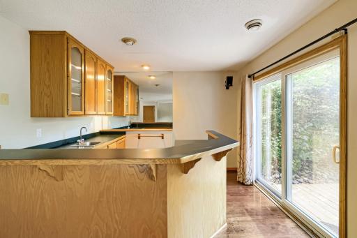 What a fantastic bonus feature to this home! This spacious lower-level wet bar is designed for entertaining, featuring an expansive wraparound countertop, beautiful oak cabinetry, and plenty of room for seating and gathering with family and friends.