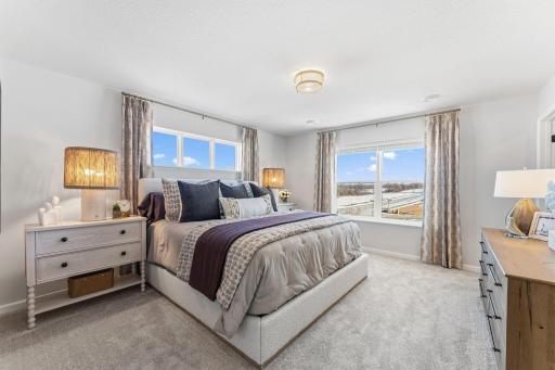 Wake up to sunshine in this spacious owner's suite, featuring large windows and plenty of room to make it your own. *Photo of a previously built home of the same floor plan. Finishes/options may vary.