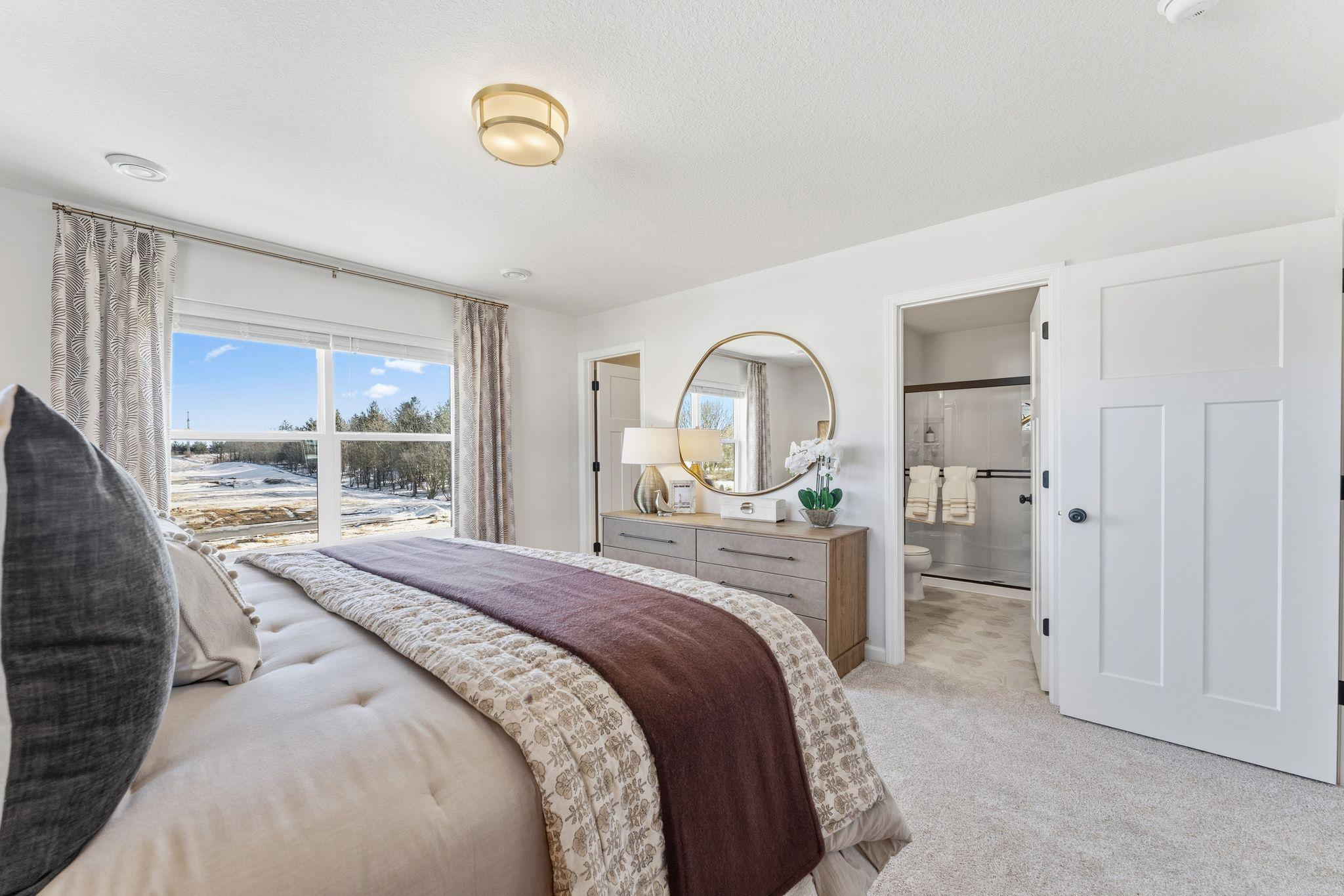 Your own private escape! This owner's suite features a large window and convenient access to the ensuite bathroom. *Photo of a previously built home of the same floor plan. Finishes/options may vary.