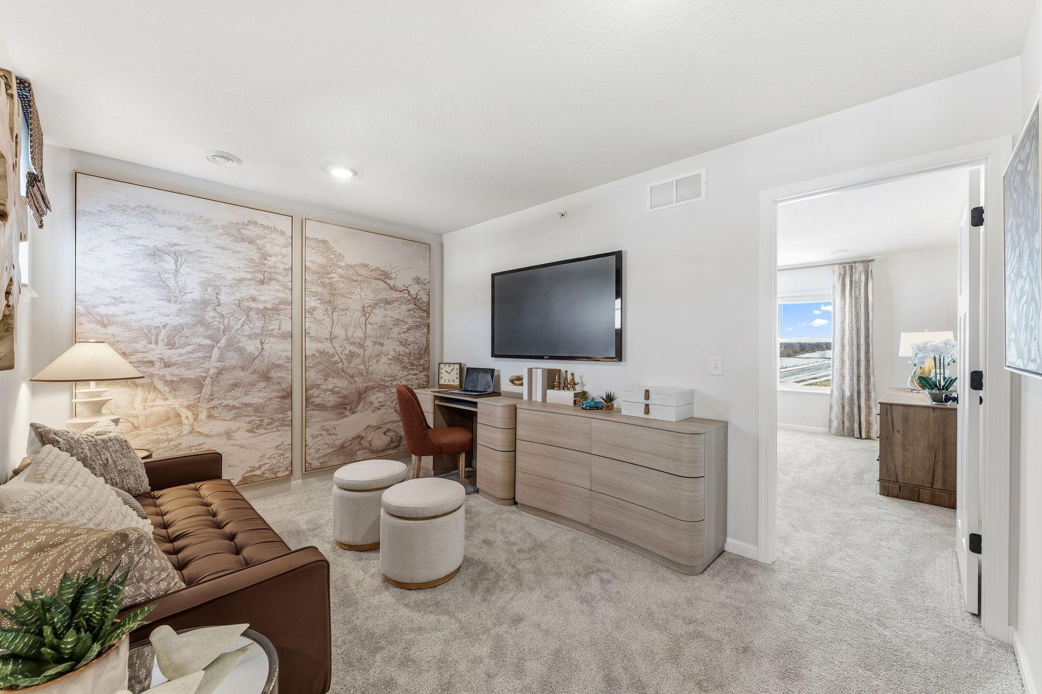 A versatile upper-level loft offers the perfect space for a home office, movie nights, or a second living area. *Photo of a previously built home of the same floor plan. Finishes/options may vary.