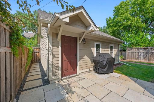 The insulated detached 2-car garage offers built-in cabinetry for storage and pull-down stairs providing access to additional storage.