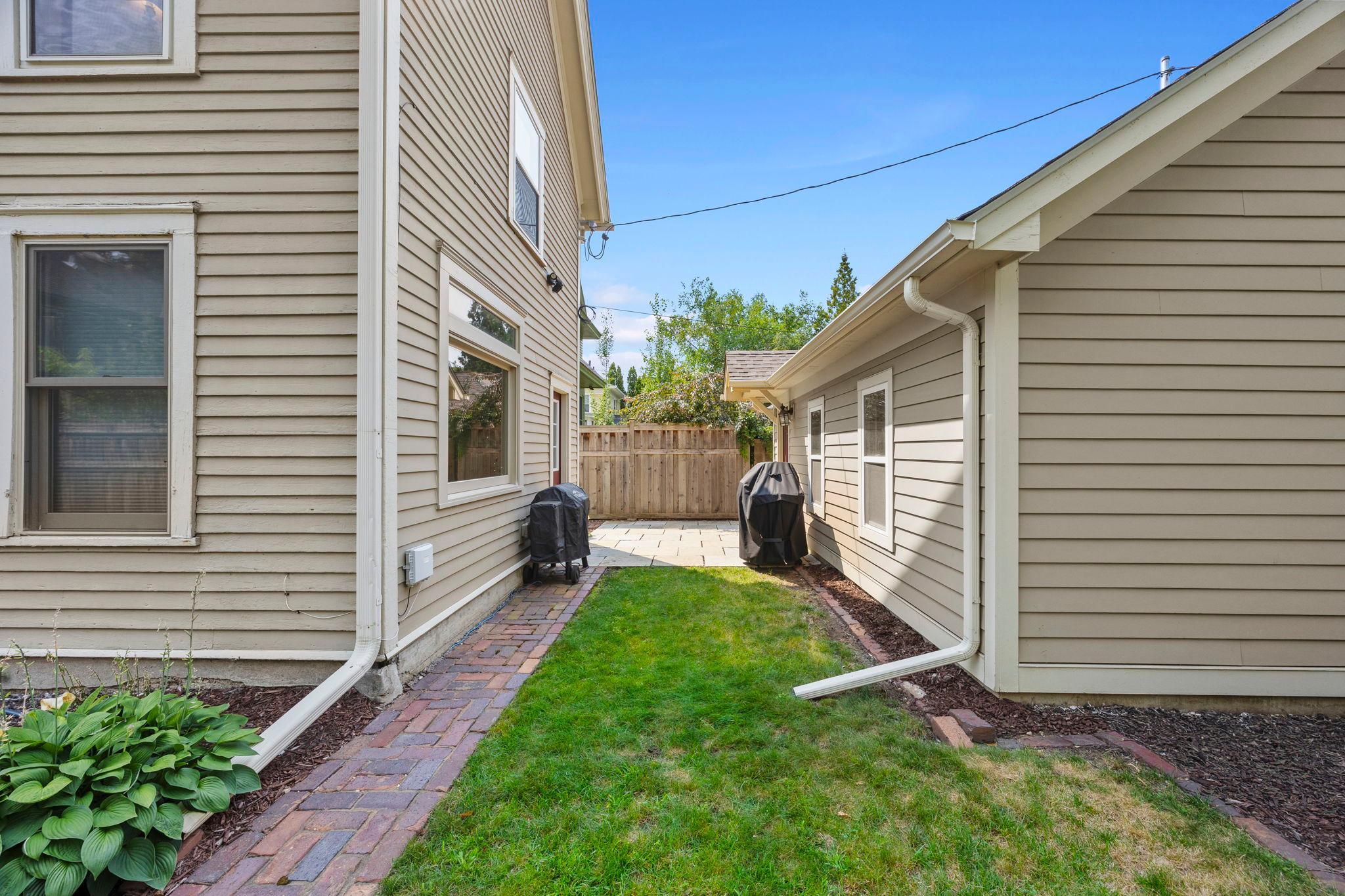 A second patio space is accessible from the mudroom/laundry room and conveniently located near the detached 2-car garage.