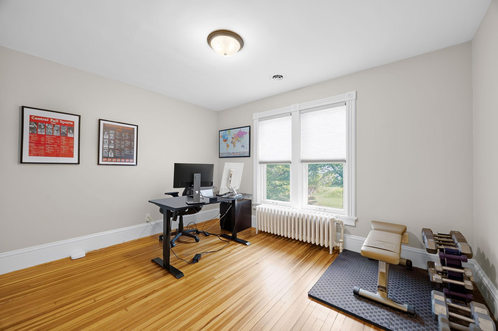 A look at the second bedroom featuring hardwood floors and a spacious walk-in closet.