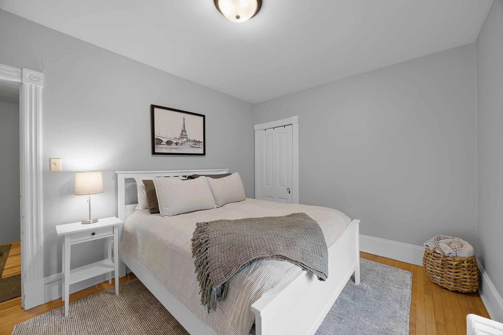 Bedroom three offers a comfortable retreat with hardwood floors and ample closet space.