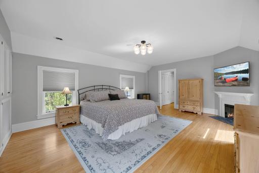The upper level features four spacious bedrooms, including an inviting primary suite with a cozy electric fireplace, hardwood floors, built-in cabinetry for storage, and a charming built-in bench overlooking the backyard.