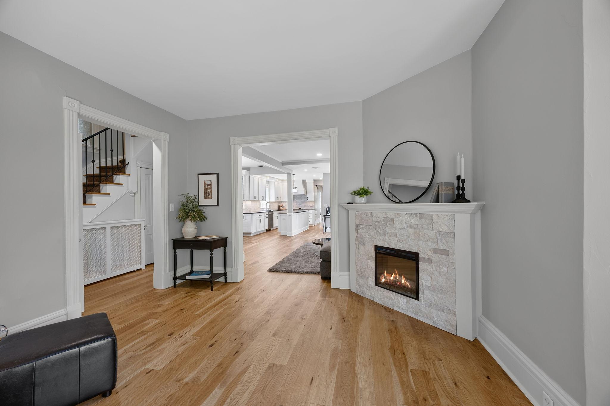 Another angle of the sitting room showcasing views into the living room and entry space.
