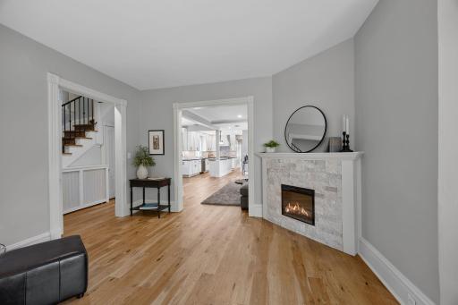 Another angle of the sitting room showcasing views into the living room and entry space.