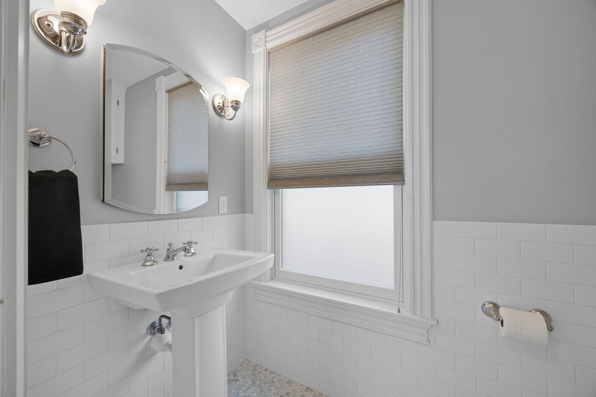 A convenient nearby half bathroom with heated floors adds functionality and comfort.