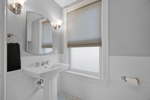A convenient nearby half bathroom with heated floors adds functionality and comfort.