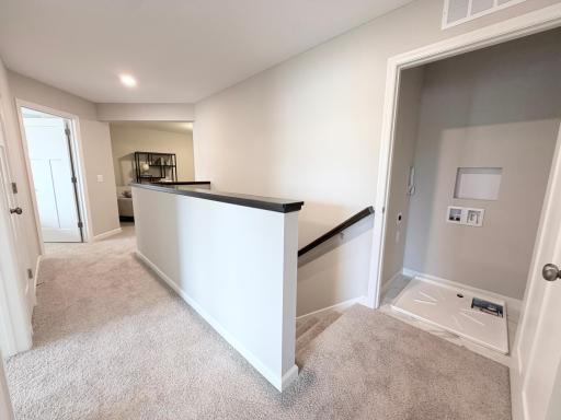 Upstairs landing with laundry closet exactly where you need it - next to the bedrooms!