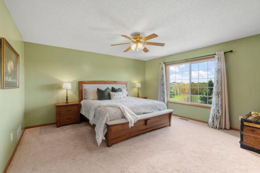 Wake up to sunshine and peaceful views of the open green space behind the home.