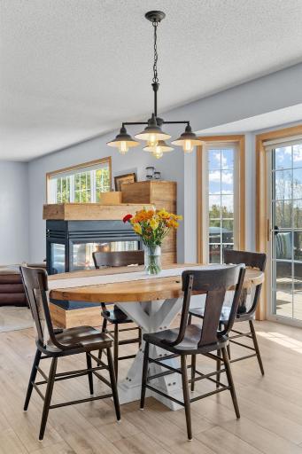 Gather around the table for family dinners or entertain friends beside the warmth of the double-sided fireplace.