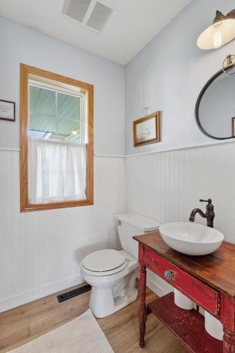 A charming half bath with rustic touches adds character and convenience for you and your guests.