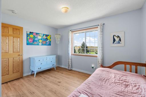 Upper level bedroom 3. Wake up to sunshine and beautiful views of the trees and green space beyond your backyard.