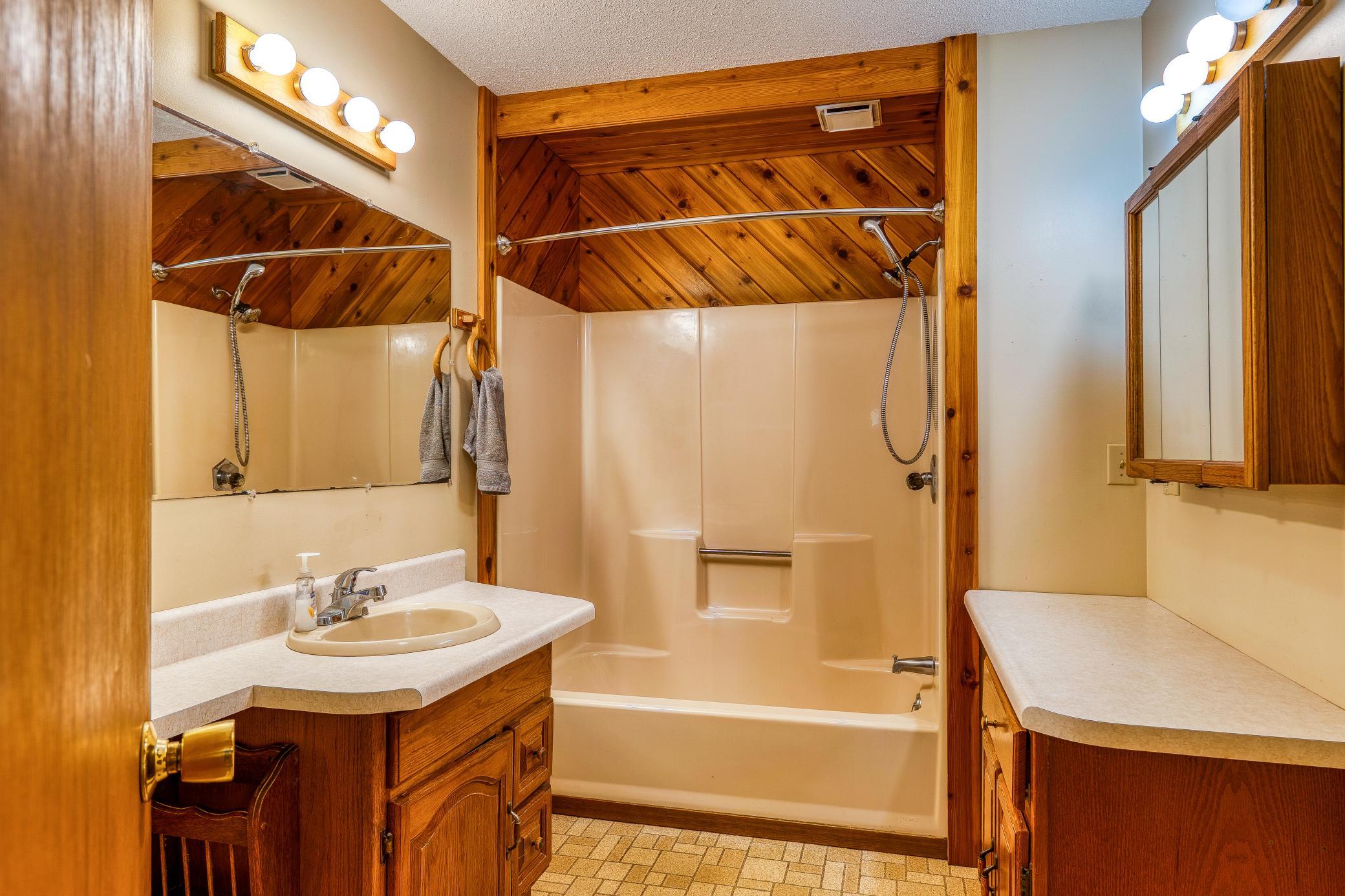 Main floor full bathroom with two vanities