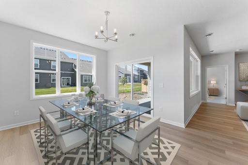 Enjoy dining surrounded by natural light. Easy access to your covered patio for easy indoor/outdoor entertaining. Similar home shown. Color and options can vary.