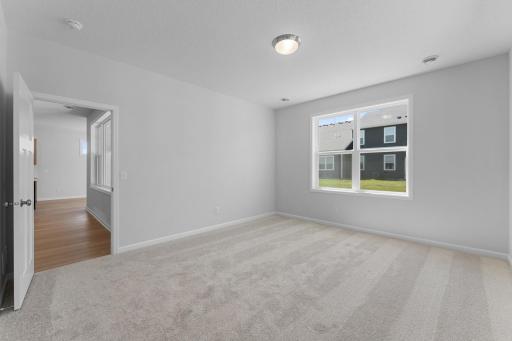 Another view of the spacious primary bedroom. Similar home shown. Color and options can vary.