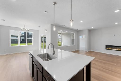 The open and inviting layout includes generous use of windows filling the home with loads of natural light. The luxury vinyl plank floors provide a seamless transition for a spacious feel. Similar home shown. Color and options can vary.