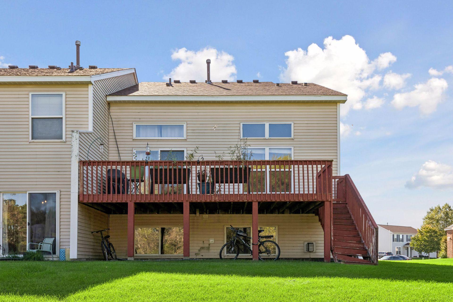 Deck off the back of the home with stairs down to the backyard