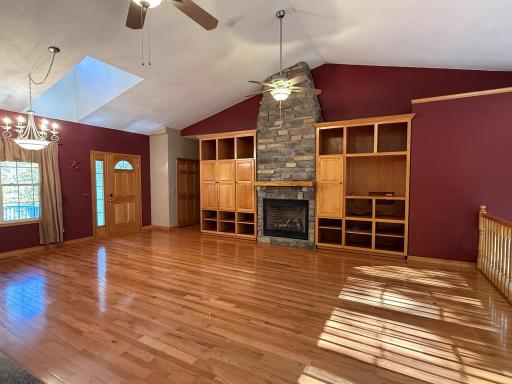 Vaulted ceiling with gas fireplace and built in cabinets.