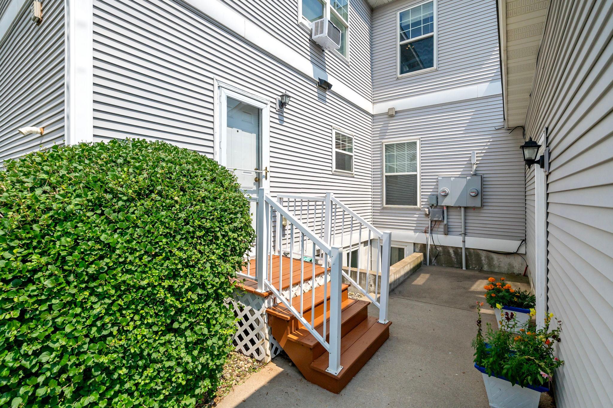 Private back patio and entrance to garage