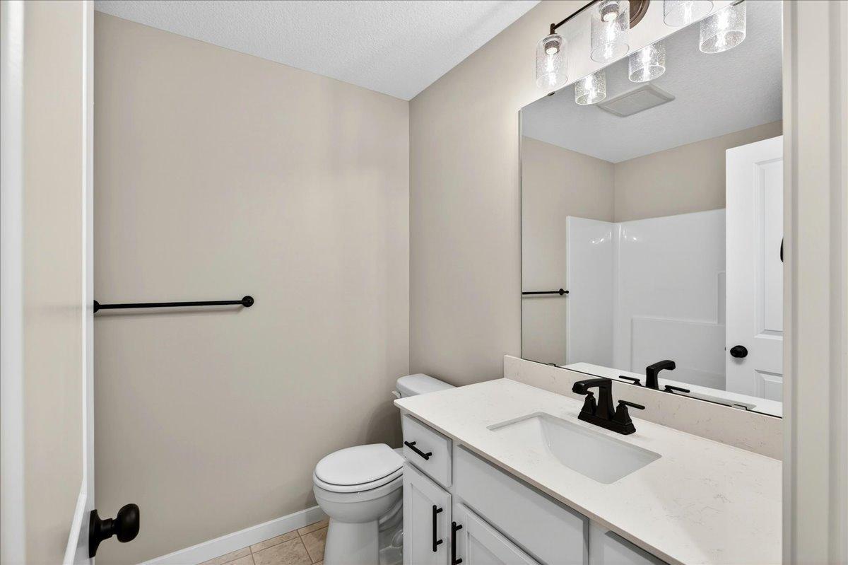 Main Bathroom. Photo taken of another home with similar plan and finishes.