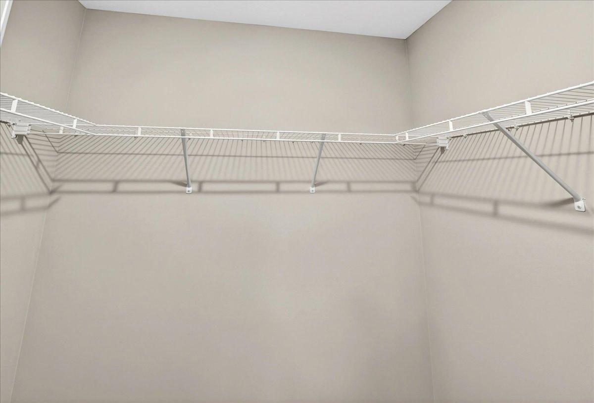 Primary Suite Walk In Closet. Photo taken of another home with similar plan and finishes.