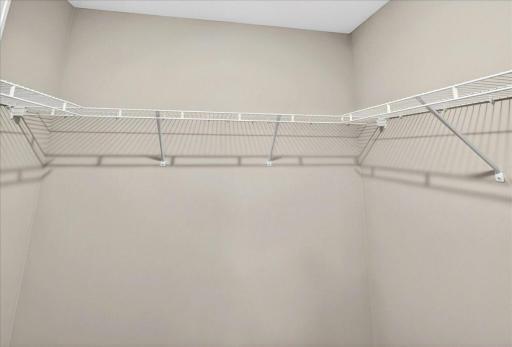 Primary Suite Walk In Closet. Photo taken of another home with similar plan and finishes.