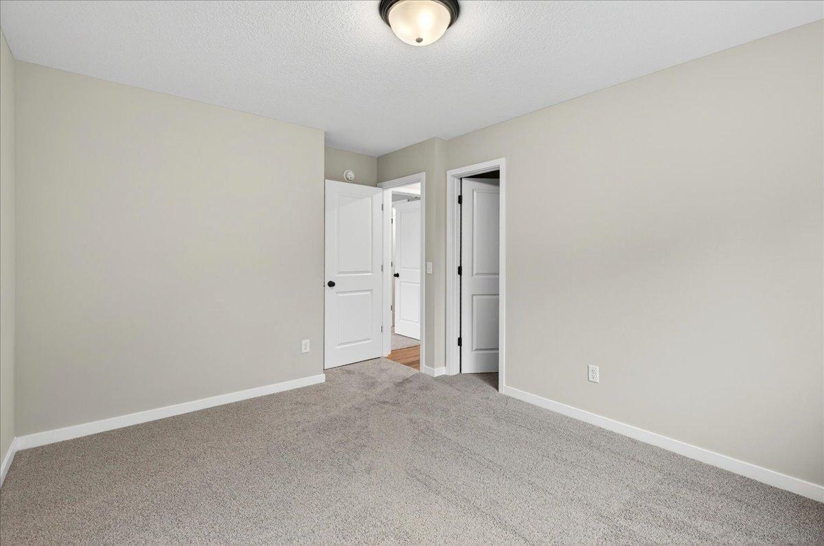 Bedroom 3. Photo taken of another home with similar plan and finishes.