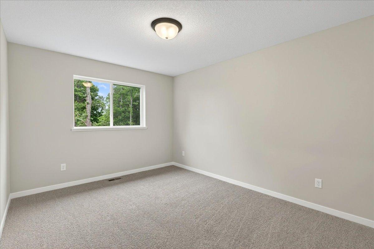 Bedroom 3. Photo taken of another home with similar plan and finishes.