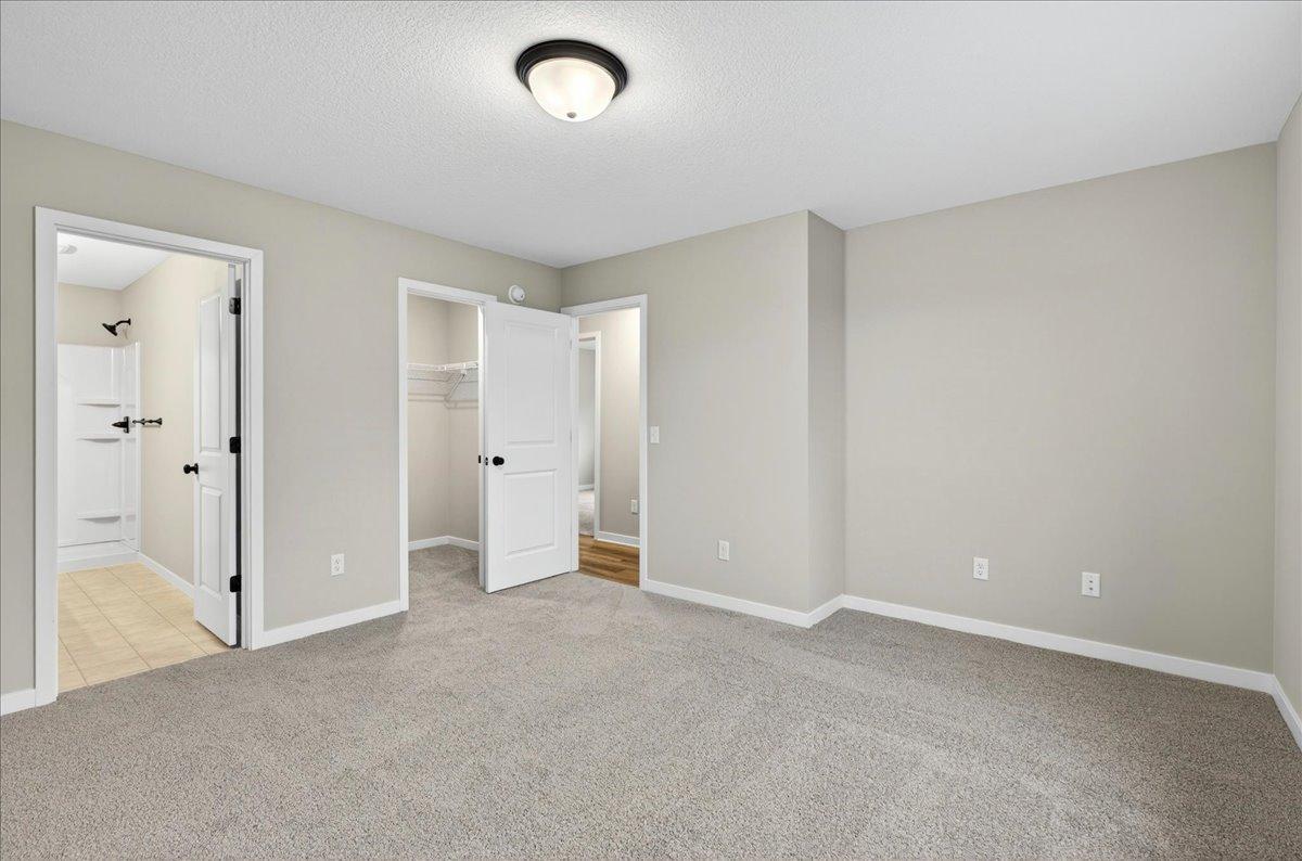 Primary Suite. Photo taken of another home with similar plan and finishes.