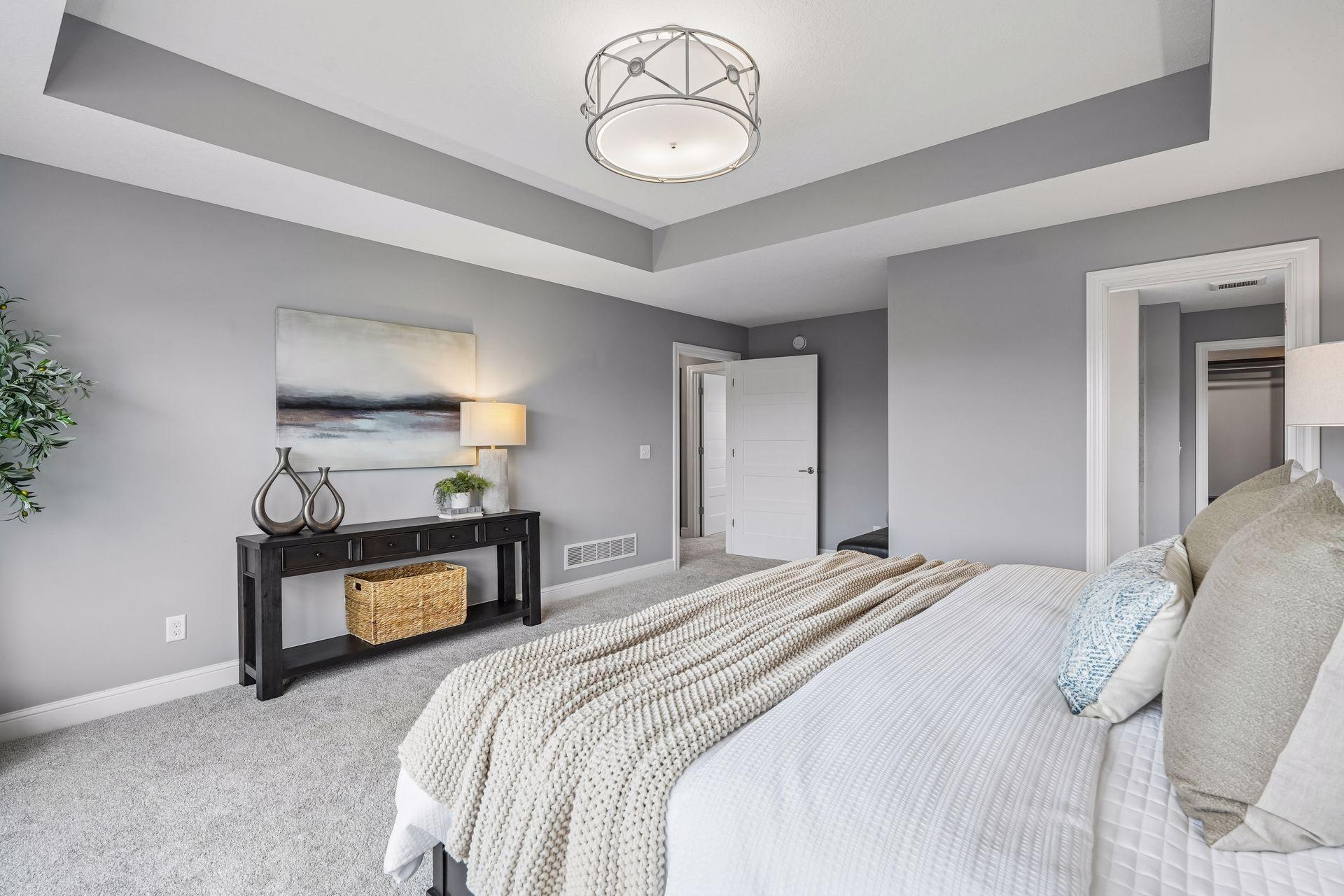 The elegant tray ceiling adds architectural interest to the expansive primary suite.