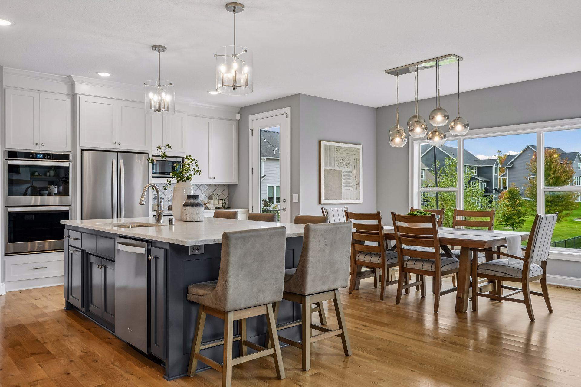 A kitchen designed to impress, featuring an oversized granite center island and custom enameled cabinetry.