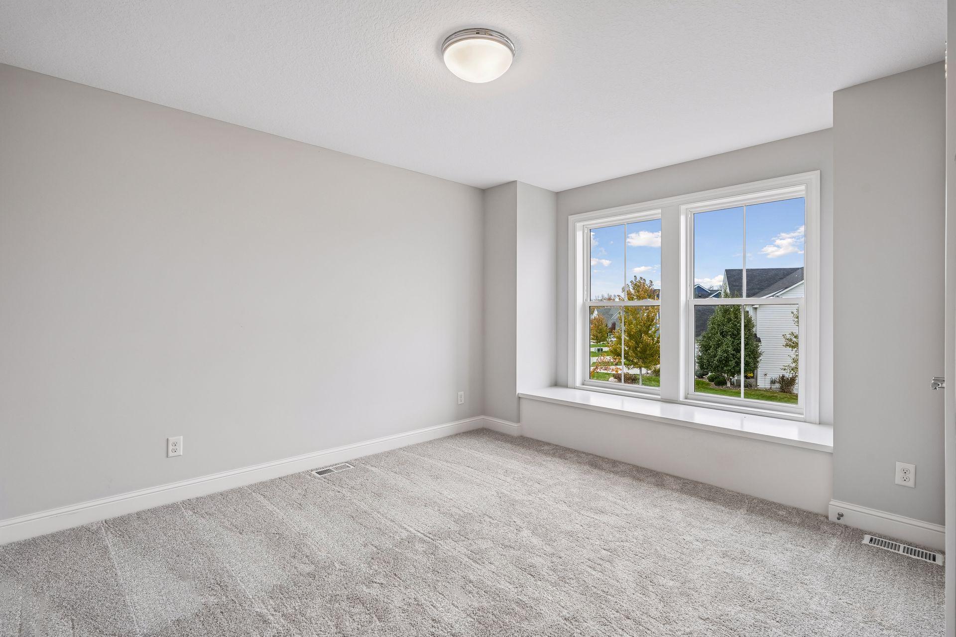 A spacious upper-level bedroom with convenient access to a shared Jack-and-Jill bathroom.