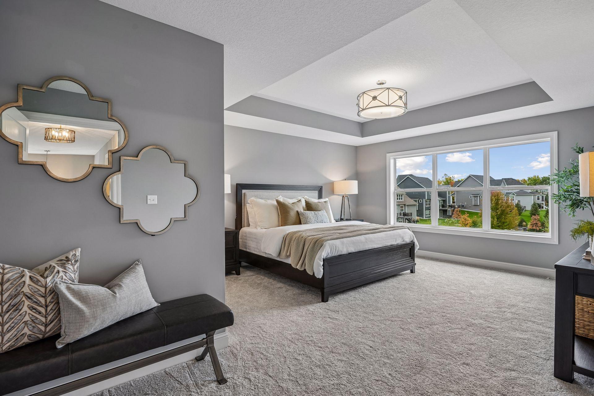 A spacious primary bedroom designed for comfort and relaxation, featuring a sophisticated tray ceiling.