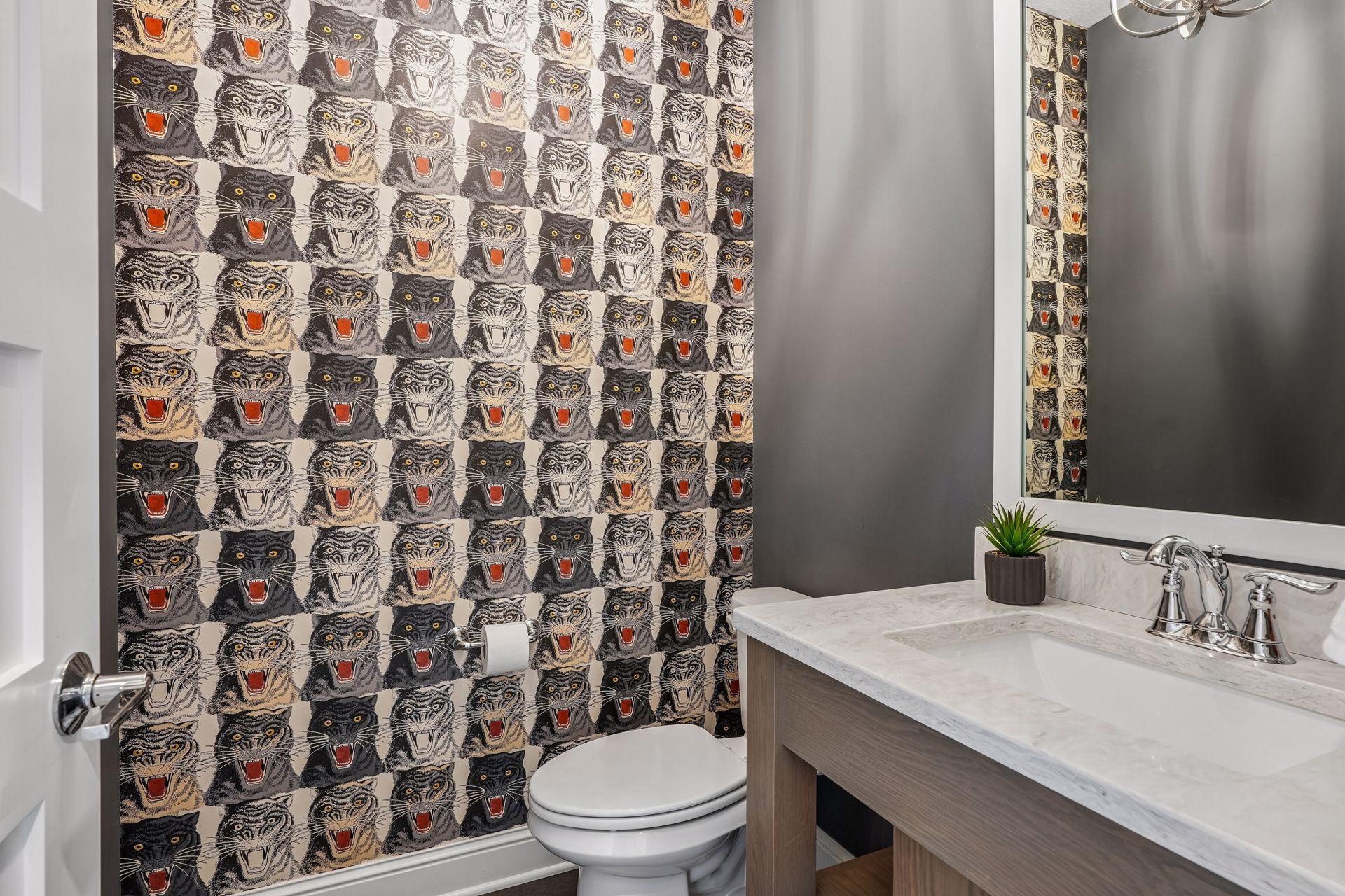 Convenient ½ bath on the main level with custom wallpaper!
