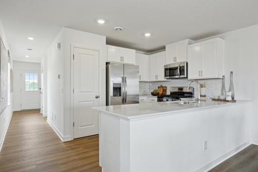 (Photo of a decorated model. Features and finishes will vary.) The bright and welcoming foyer flows effortlessly to the kitchen.