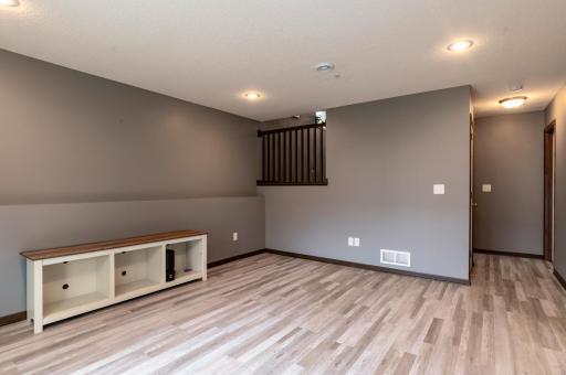 Lower level family room has newer LVP for easy cleaning.jpg