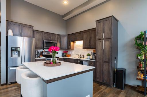 Luxury kitchen with quartz countertops, stainless steel appliances and subway tile backsplash.jpg