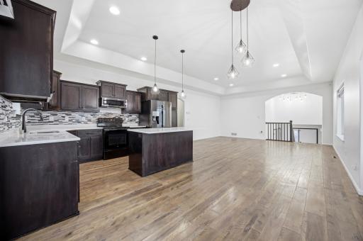 Dining to Kitchen/Living Room (updated fixtures & flooring)