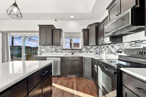 Kitchen (granite countertops surround; spacious island; range w/air fryer & microwave - new in 2023)